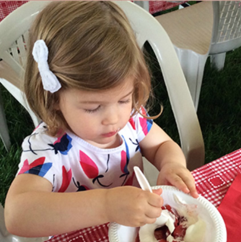 Little girl eating strawberry shortcake